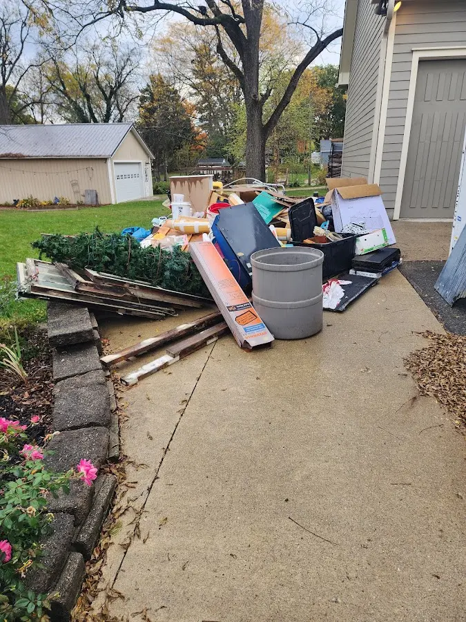 Dumpster being loaded with debris for 3 Yard Dumpster Rental in Dripping Springs